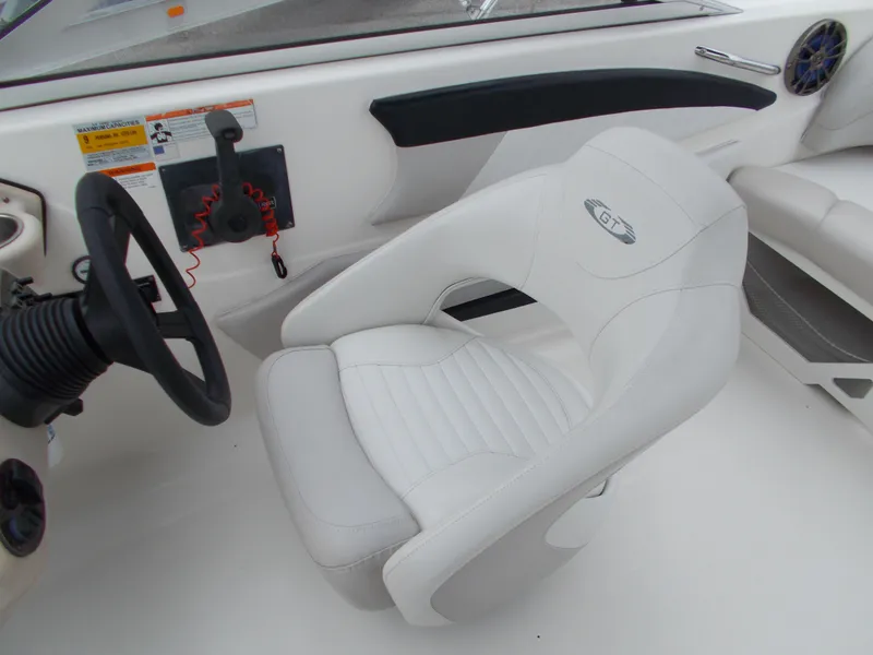 Slide: The Image of 2008 Glastron GT 205 boat interior with white captain's chair and steering wheel. - 12