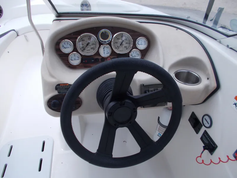 Slide: The Image of 2008 Glastron GT 205 boat dashboard with steering wheel and gauges. - 18