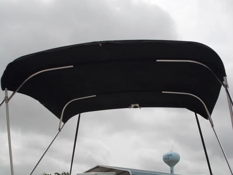 Slide: The Image of Bimini top of a 2008 Glastron GT 205 boat against a cloudy sky. - 8