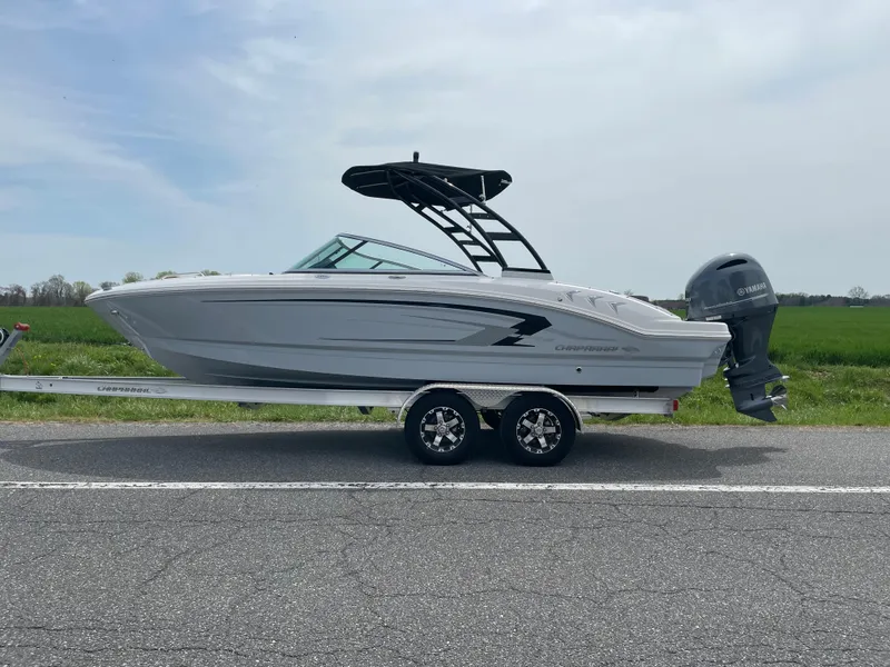 The Image of 2024 Chaparral 21 SSi OB boat on a trailer, side view, outdoors. - 0