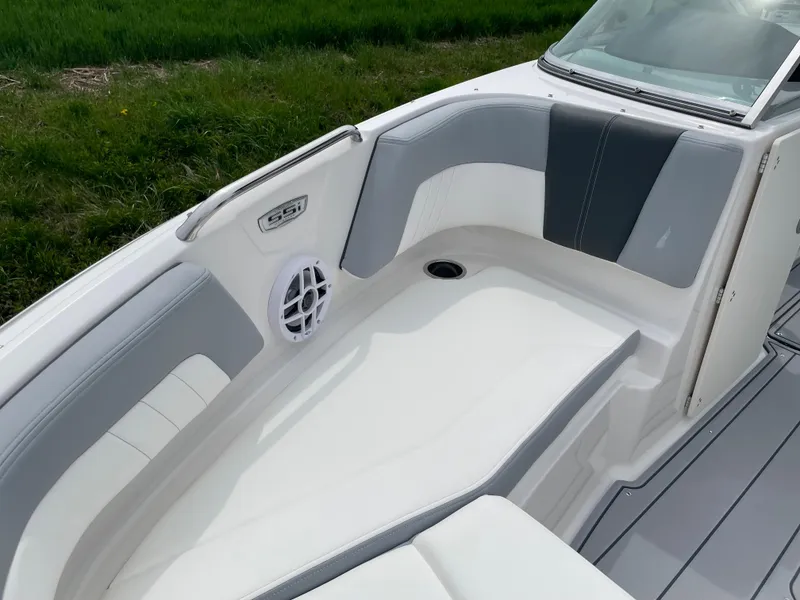 Slide: The Image of 2024 Chaparral 21 SSi OB boat interior with white and gray seating. - 11