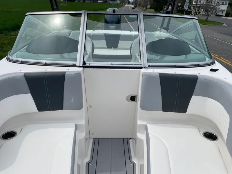 Slide: The Image of 2024 Chaparral 21 SSi OB boat interior with windshield and seating. - 16