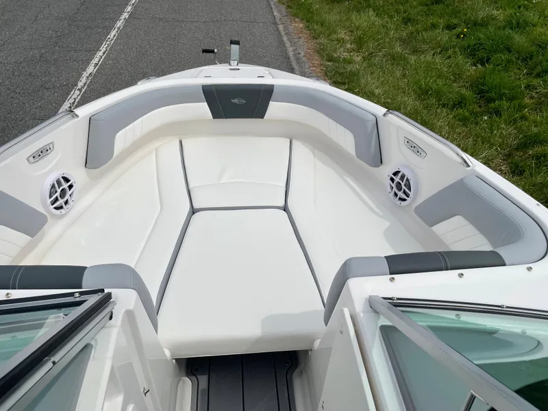 Slide: The Image of 2024 Chaparral 21 SSi OB boat with white and gray interior seating. - 17
