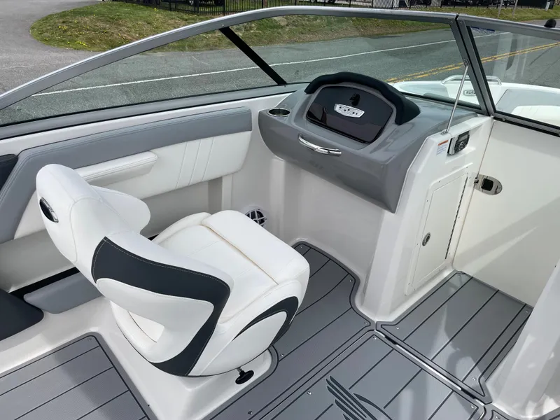 Slide: The Image of 2024 Chaparral 21 SSi OB boat interior with captain's chair and dashboard. - 18