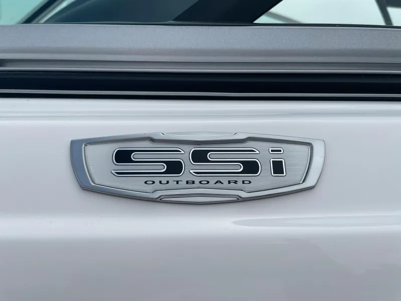 Slide: The Image of 2024 Chaparral 21 SSi OB outboard emblem on white boat. - 2