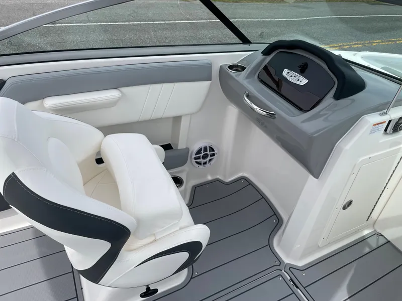 Slide: The Image of 2024 Chaparral 21 SSi OB boat interior with white and gray seating and dashboard. - 20