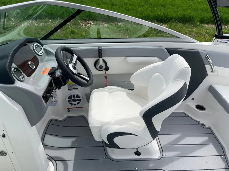 Slide: The Image of 2024 Chaparral 21 SSi OB boat interior, featuring a sleek captain's chair and modern dashboard. - 21