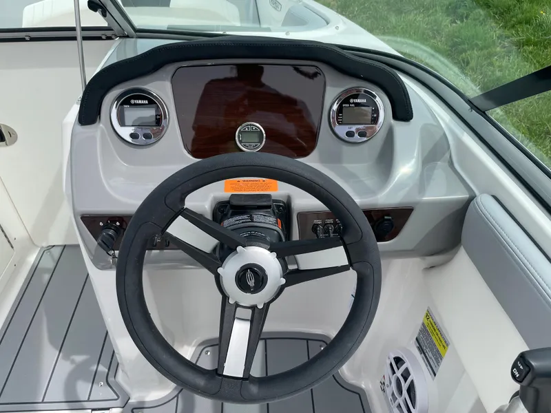 Slide: The Image of 2024 Chaparral 21 SSi OB boat dashboard with steering wheel and instrument panel. - 22