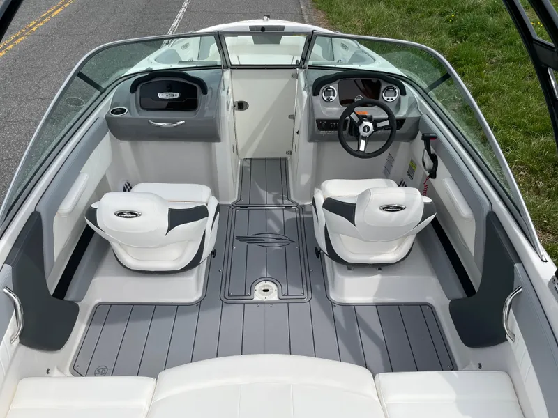 Slide: The Image of 2024 Chaparral 21 SSi OB boat interior with dual captain seats and modern dashboard. - 25