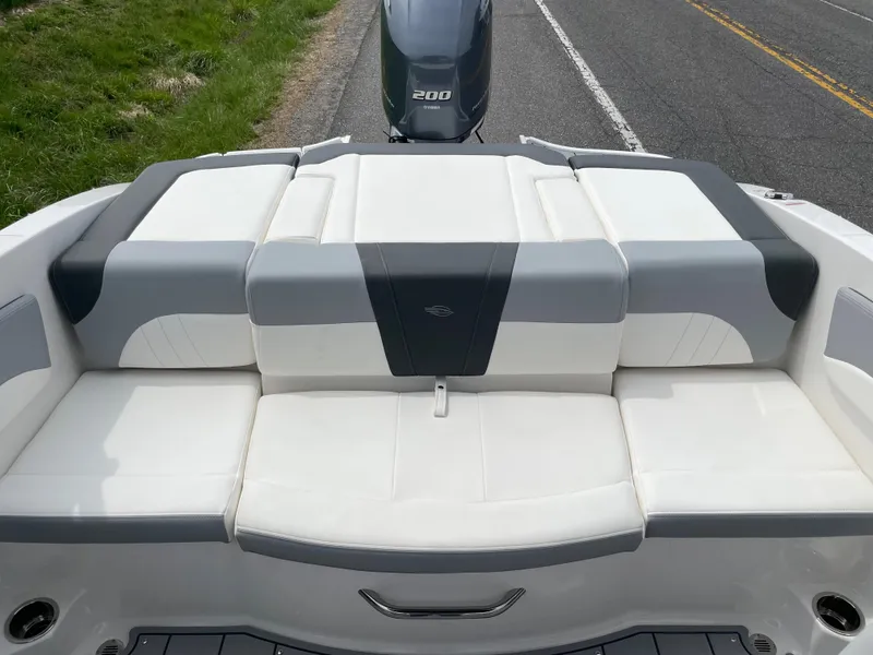 Slide: The Image of 2024 Chaparral 21 SSi OB boat with white and gray seating, rear view. - 26