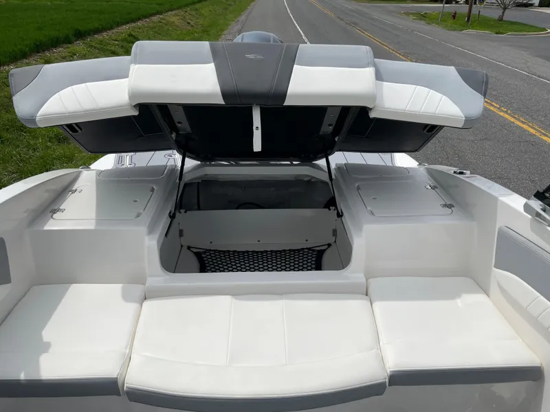 Slide: The Image of 2024 Chaparral 21 SSi OB boat with open storage compartment. - 27