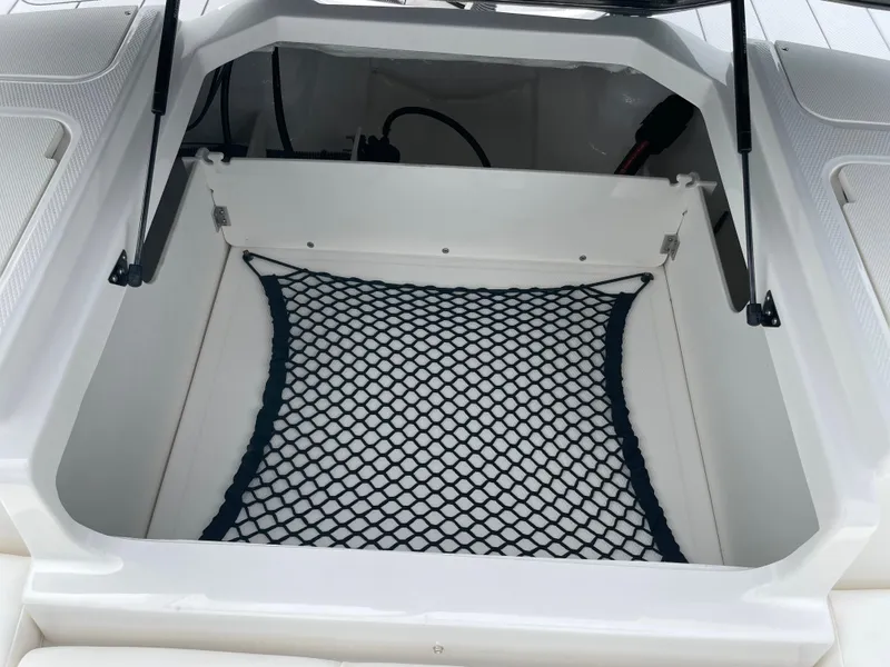 Slide: The Image of 2024 Chaparral 21 SSi OB boat storage compartment with netting. - 28
