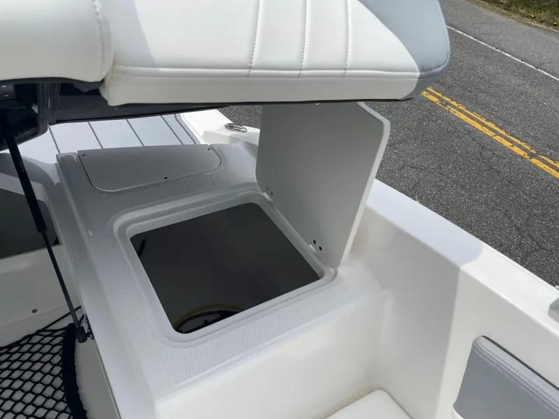 Slide: The Image of 2024 Chaparral 21 SSi OB boat storage compartment with open hatch. - 29