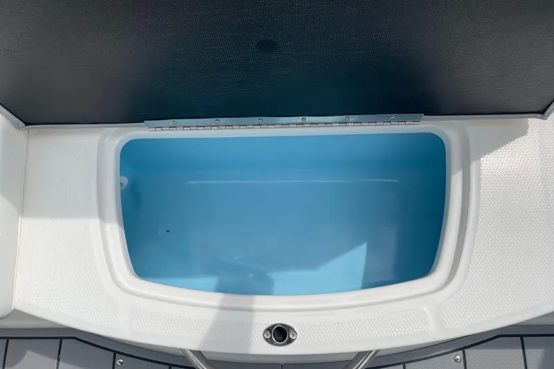 Slide: The Image of 2024 Chaparral 21 SSi OB boat storage compartment with blue interior. - 35