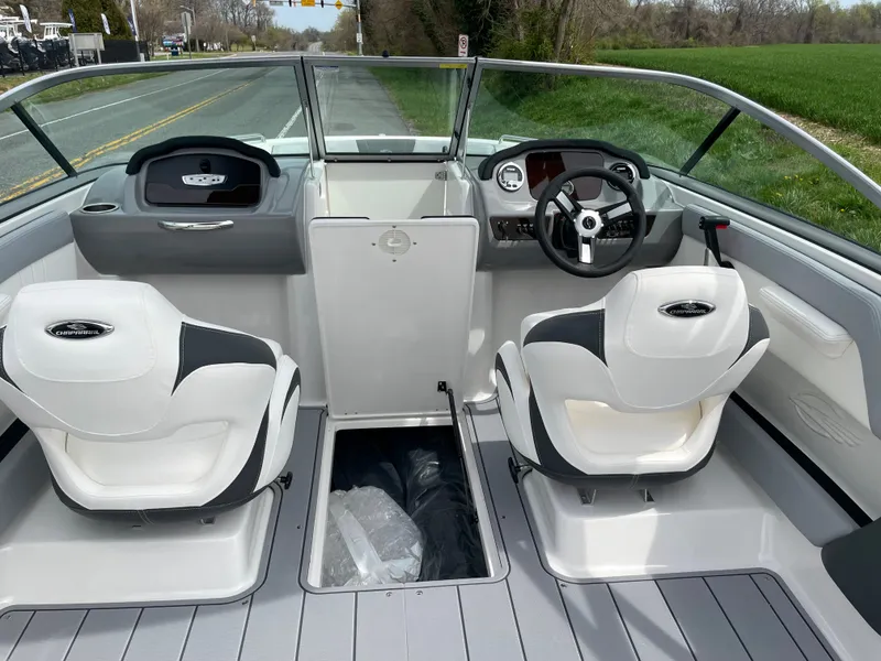 Slide: The Image of 2024 Chaparral 21 SSi OB boat interior with dual seats and steering console. - 39