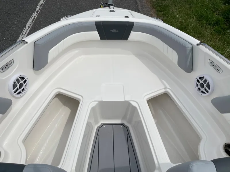 Slide: The Image of 2024 Chaparral 21 SSi OB boat interior, featuring spacious seating and storage compartments. - 6
