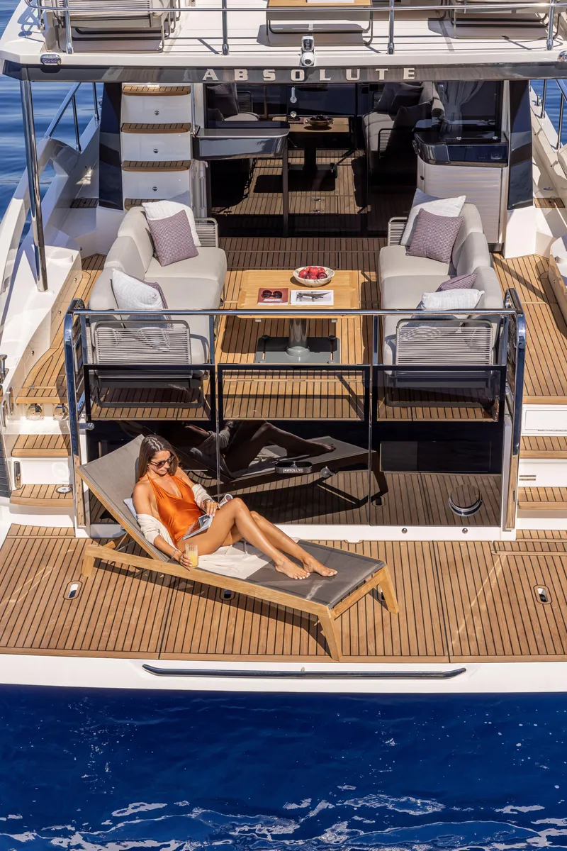 Slide: The Image of Luxury Absolute 56 FLY yacht, 2025 model, with sunbathing deck and elegant seating area. - 12
