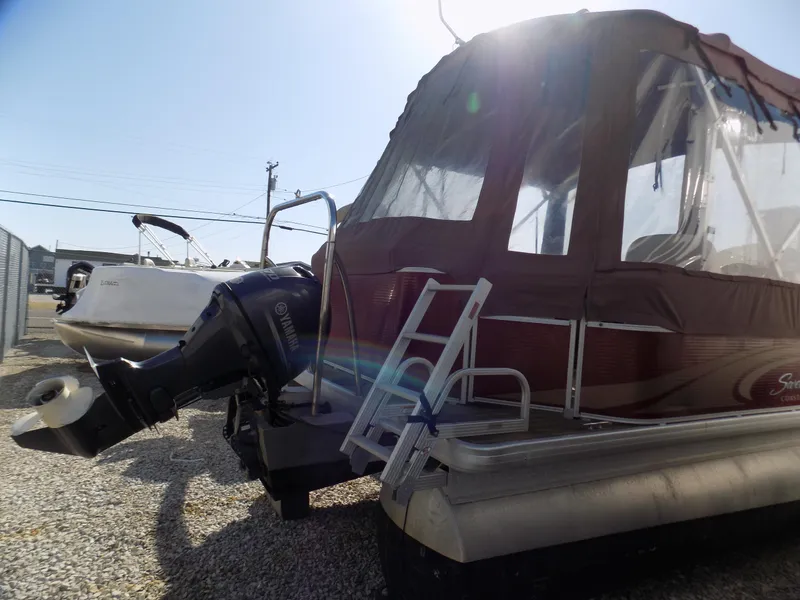Slide: The Image of 2013 Sweetwater 2086 pontoon boat with Yamaha outboard motor and canopy, parked on gravel. - 3