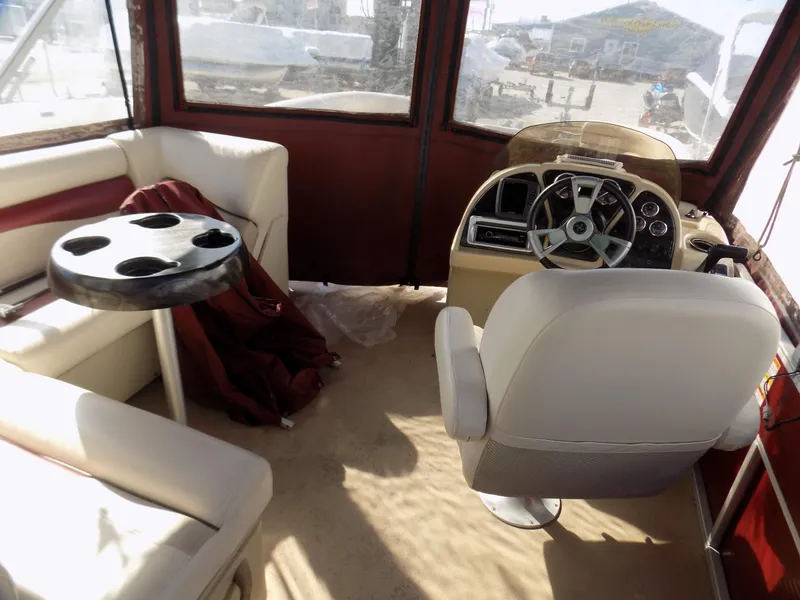 Slide: The Image of Interior of 2013 Sweetwater 2086 boat with steering wheel, seating, and cup holder table. - 5