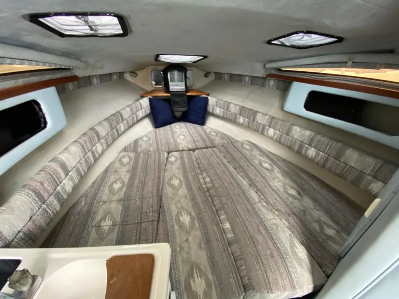 Slide: The Image of Interior cabin of a 1989 Sea Ray Sundancer boat with cushioned seating. - 13