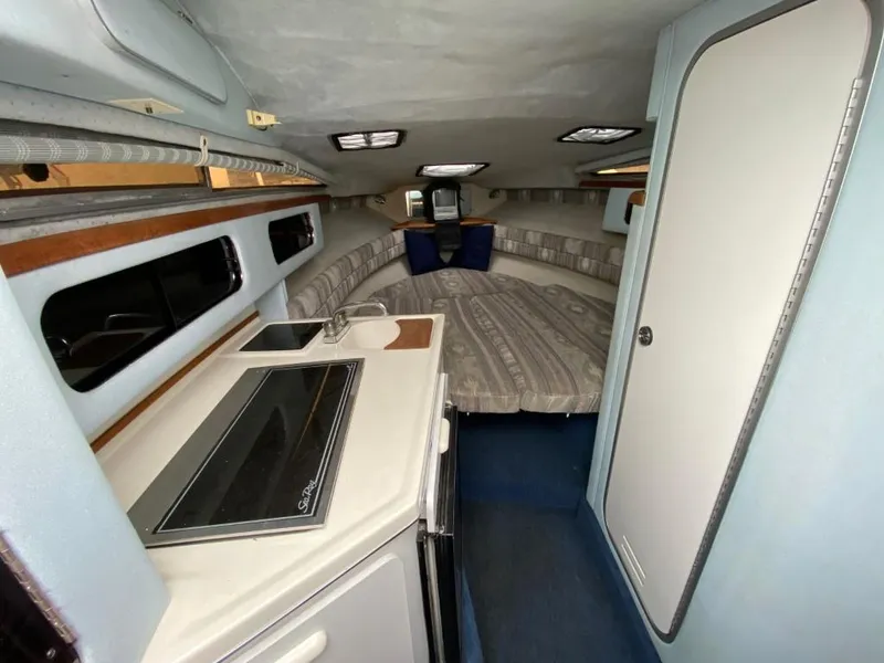 Slide: The Image of Interior of 1989 Sea Ray Sundancer boat with kitchenette and sleeping area. - 17