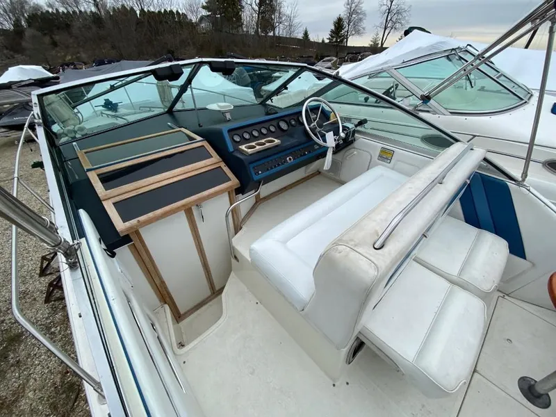 Slide: The Image of 1989 Sea Ray Sundancer boat cockpit with white seating and control panel. - 9