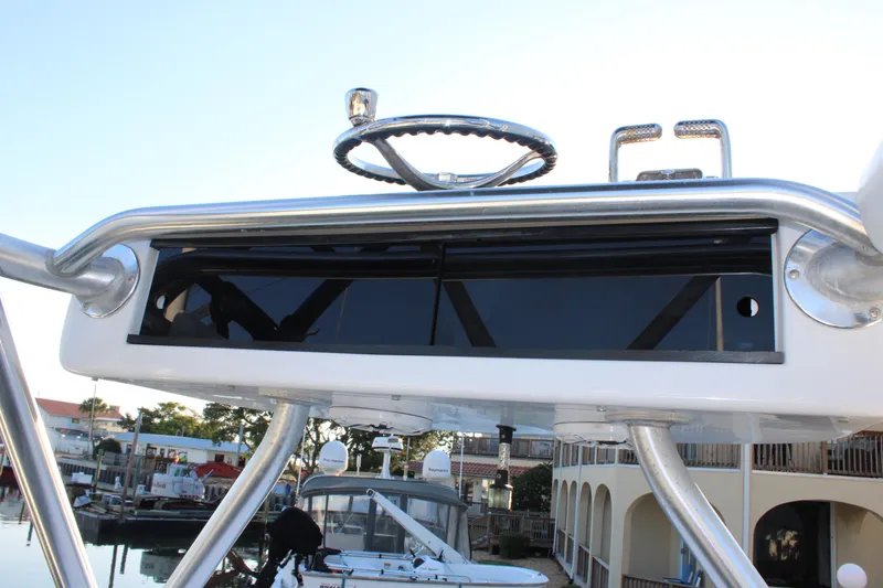 Slide: The Image of 2010 Legend 37 Walkaround boat helm station with steering wheel and controls. - 13