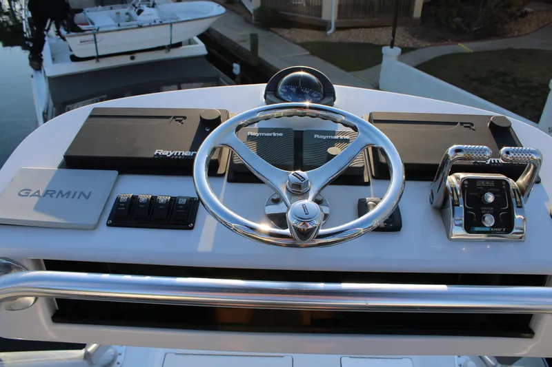 Slide: The Image of 2010 Legend 37 Walkaround boat helm with Garmin and Raymarine navigation systems. - 14