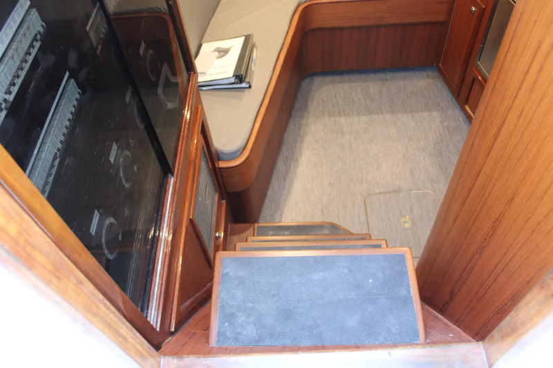 Slide: The Image of Interior cabin of 2010 Legend 37 Walkaround boat with wooden steps and seating area. - 6