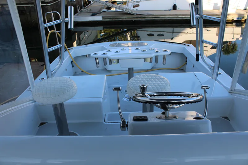 Slide: The Image of 2010 Legend 37 Walkaround boat cockpit with steering wheel and seating. - 8