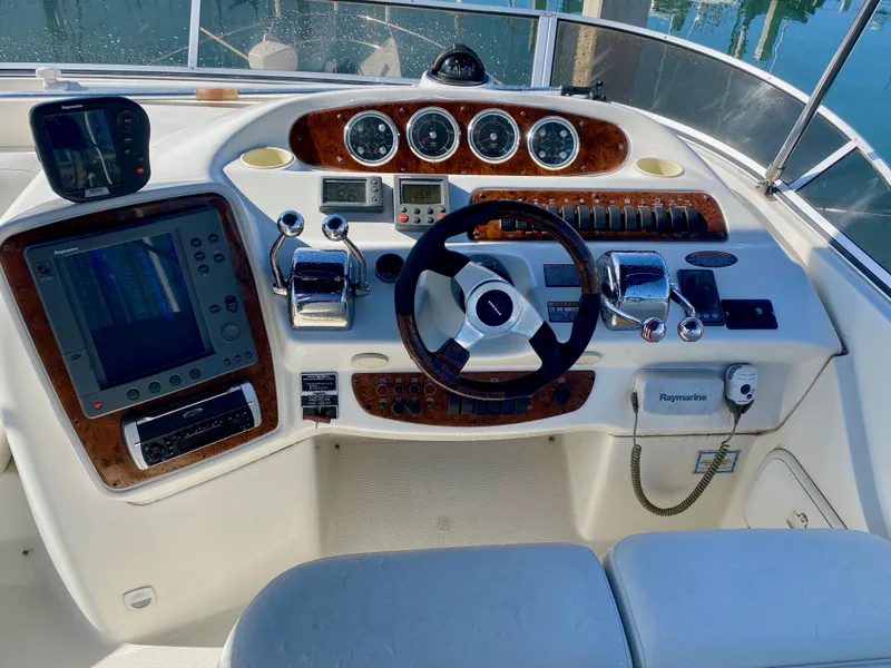 Slide: The Image of The cockpit of a 2004 Meridian 411 Sedan with modern navigation instruments and a sleek steering wheel. - 25