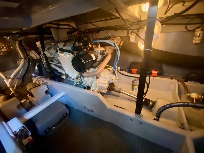 Slide: The Image of The engine room of a 2004 Meridian 411 Sedan with visible engine and piping. - 37