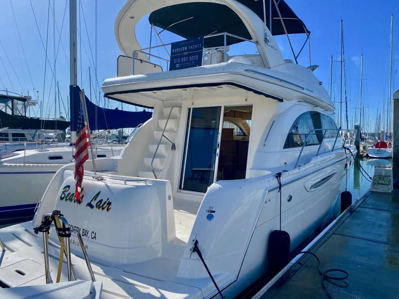 Slide: The Image of A white 2004 Meridian 411 Sedan yacht docked. It features a spacious aft deck. - 22