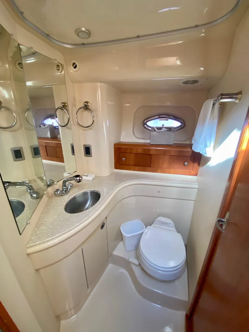 Slide: The Image of The image shows a yacht's elegant bathroom with a sink, toilet, and mirror. - 12