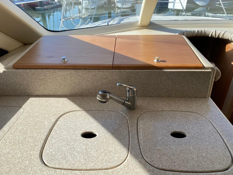 Slide: The Image of The galley of a 2004 Meridian 411 Sedan with a sink and covers. - 17