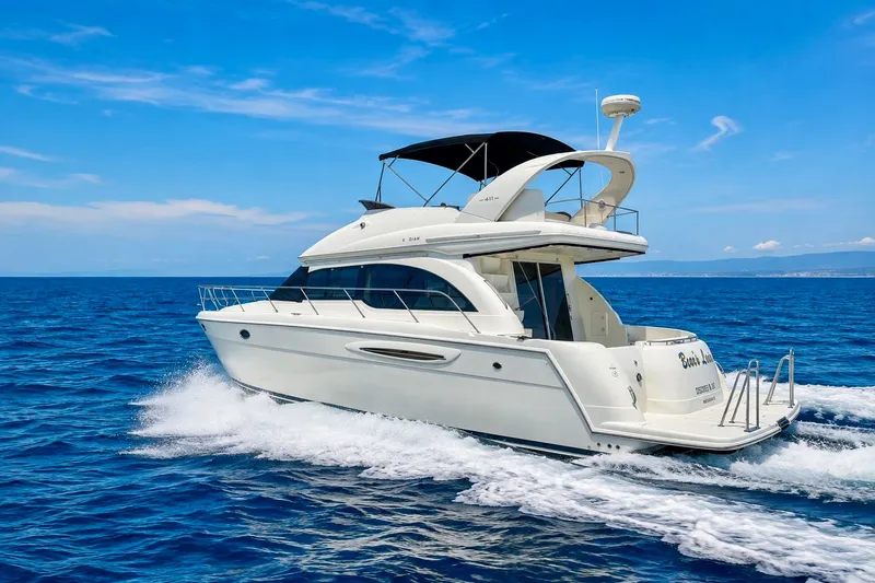 Slide: The Image of BEARS LAIR - 2004 Meridian 411 Sedan cruising on open blue ocean under clear sky. - 2