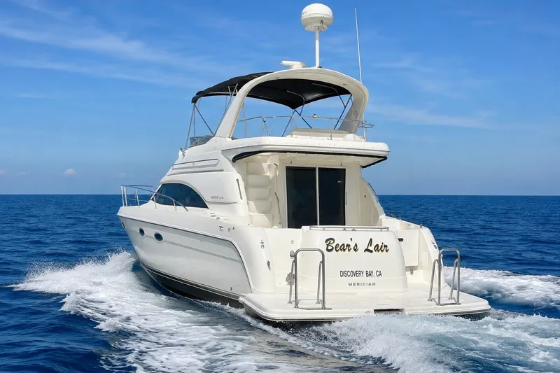 Slide: The Image of BEARS LAIR - 2004 Meridian 411 Sedan yacht cruising on open sea under clear blue sky. - 0