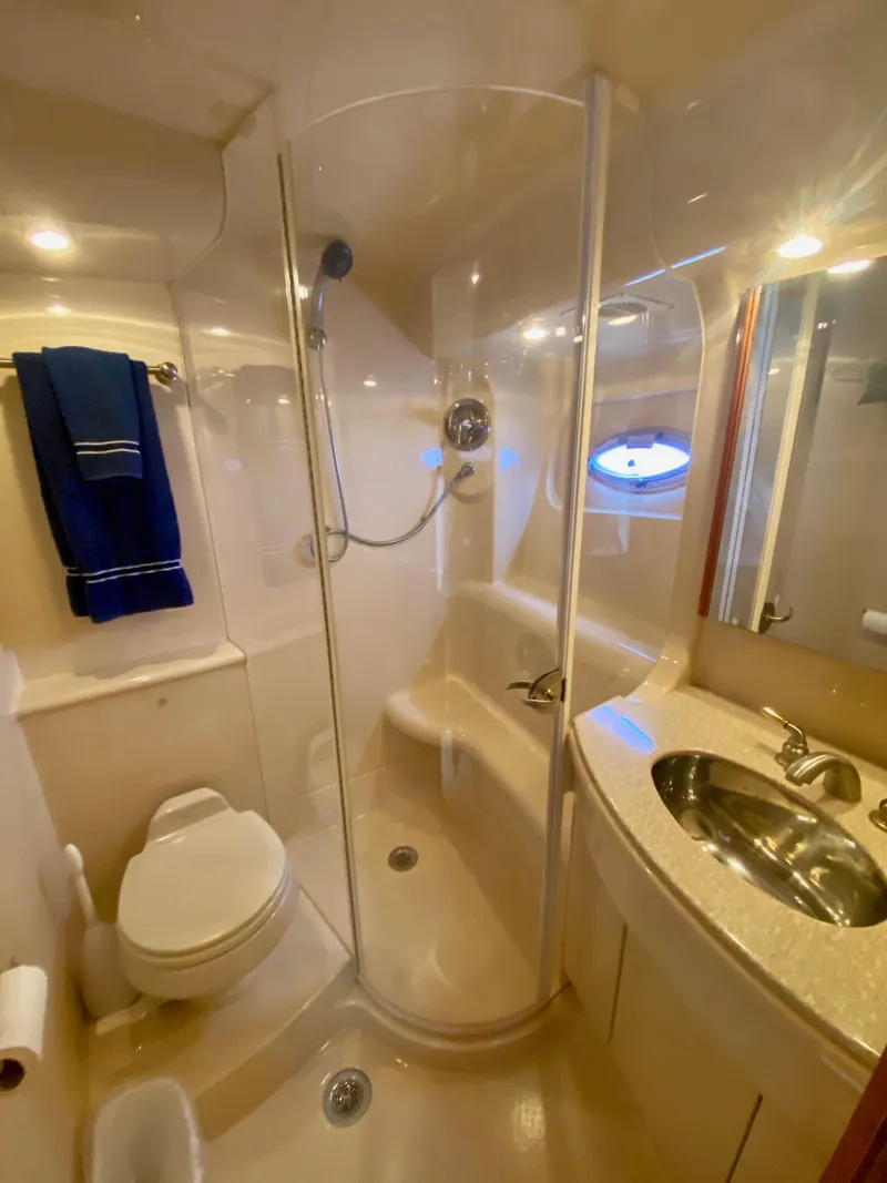 Slide: The Image of The image shows a sleek boat bathroom with a shower, sink, and toilet. - 10