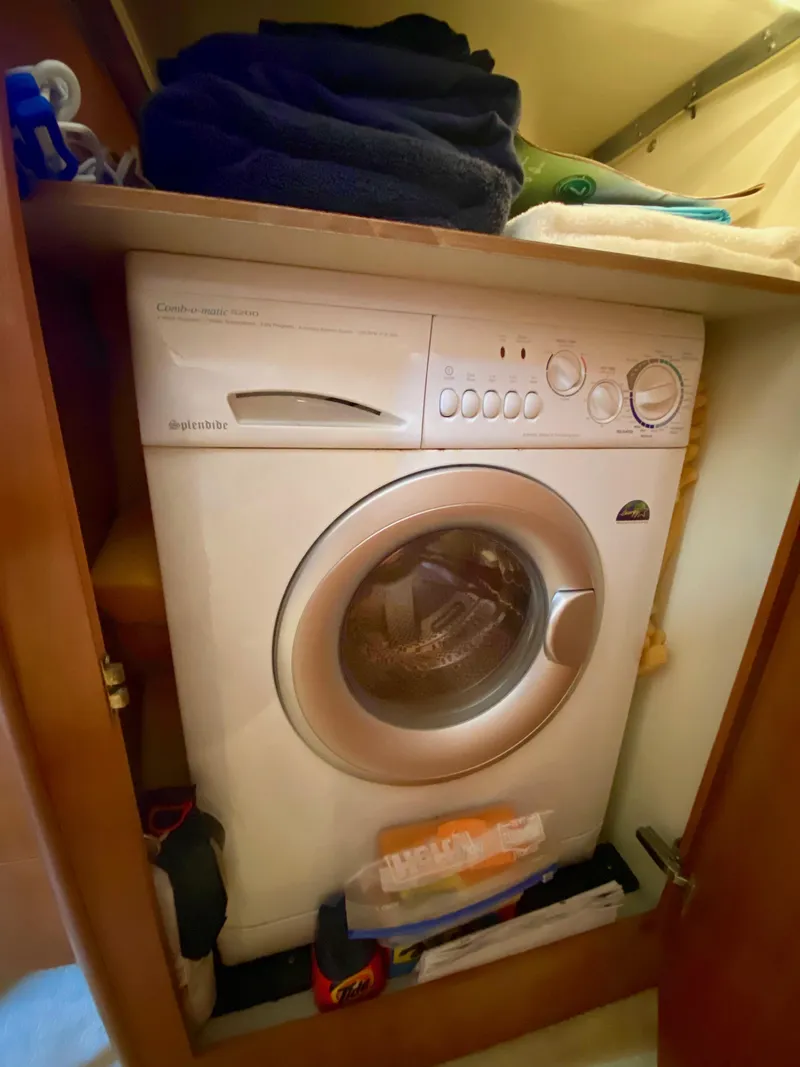 Slide: The Image of A washing machine is built into a wooden cabinet, surrounded by shelves and items. - 13