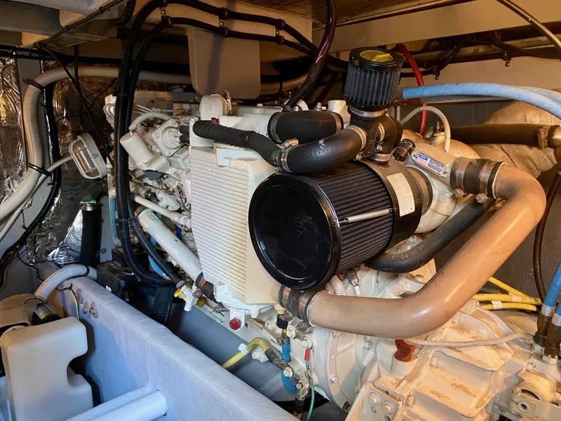 Slide: The Image of The engine room of a 2004 Meridian 411 Sedan with visible hoses and components. - 33