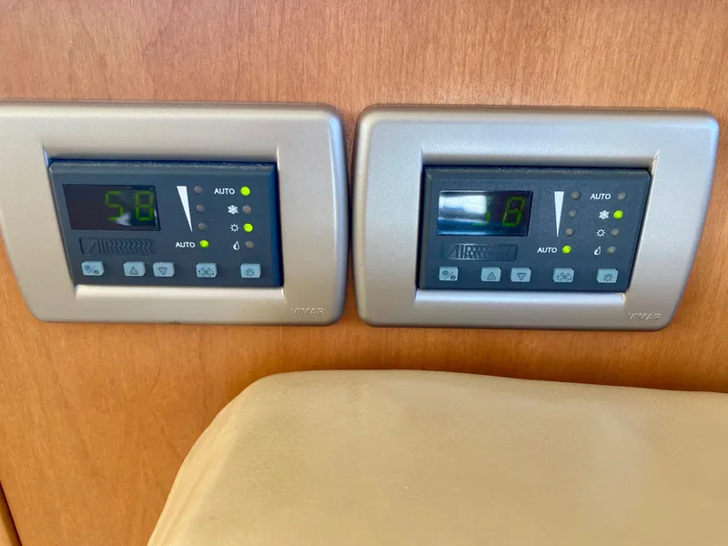 Slide: The Image of Two digital controls are set into a wooden panel, featuring green and yellow lights. - 8