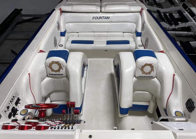 Slide: The Image of 1999 Fountain 47 Lightning boat interior with white and blue seating. - 13