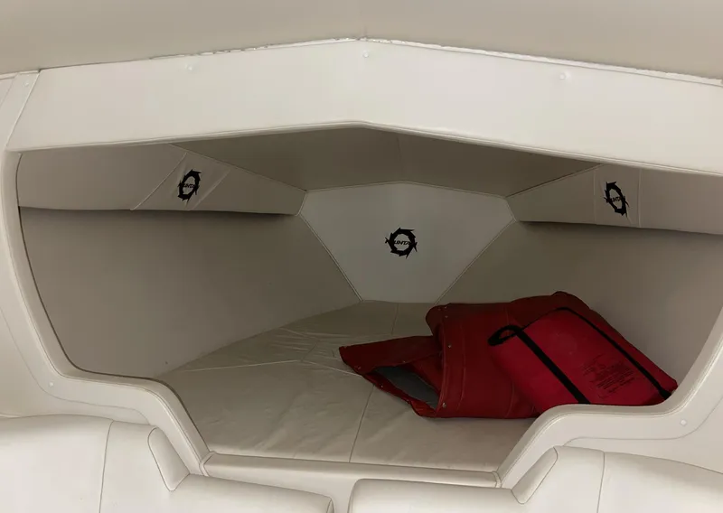 Slide: The Image of 1999 Fountain 47 Lightning boat interior cabin with white upholstery and red life jacket. - 17