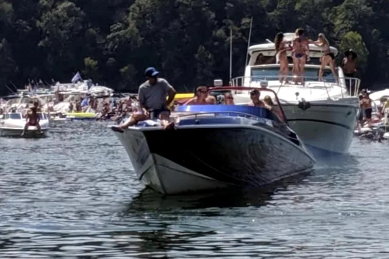 Slide: The Image of 1999 Fountain 47 Lightning boat on a crowded lake with people enjoying the water. - 6