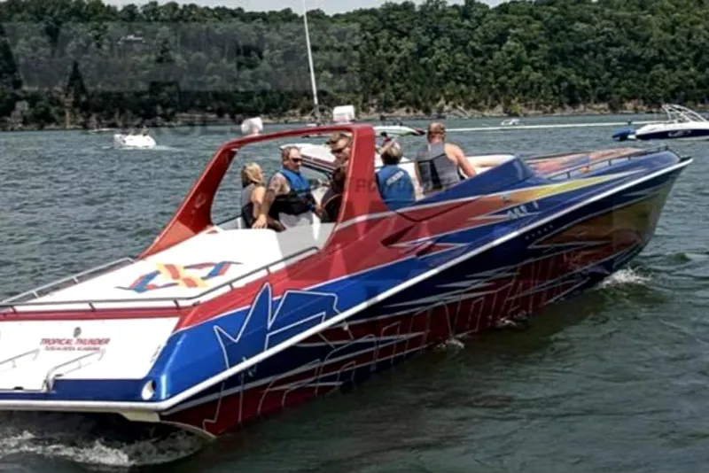 Slide: The Image of 1999 Fountain 47 Lightning speedboat on water with passengers, vibrant red and blue design. - 7
