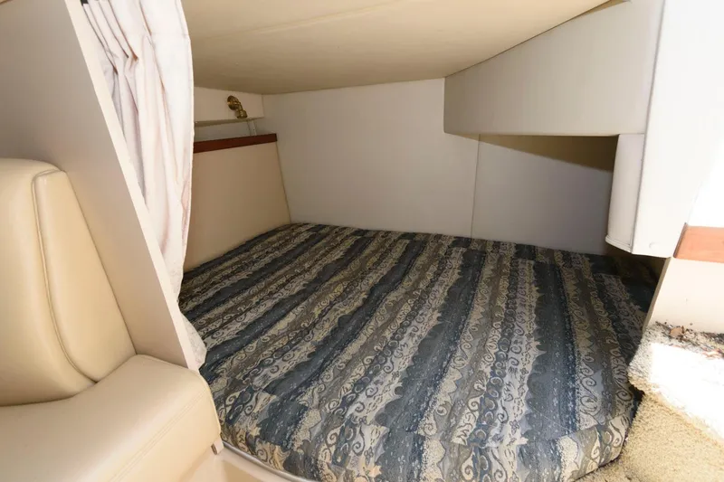 Slide: The Image of 2000 Cruisers Yachts 2870 Express cabin bed with patterned mattress. - 10