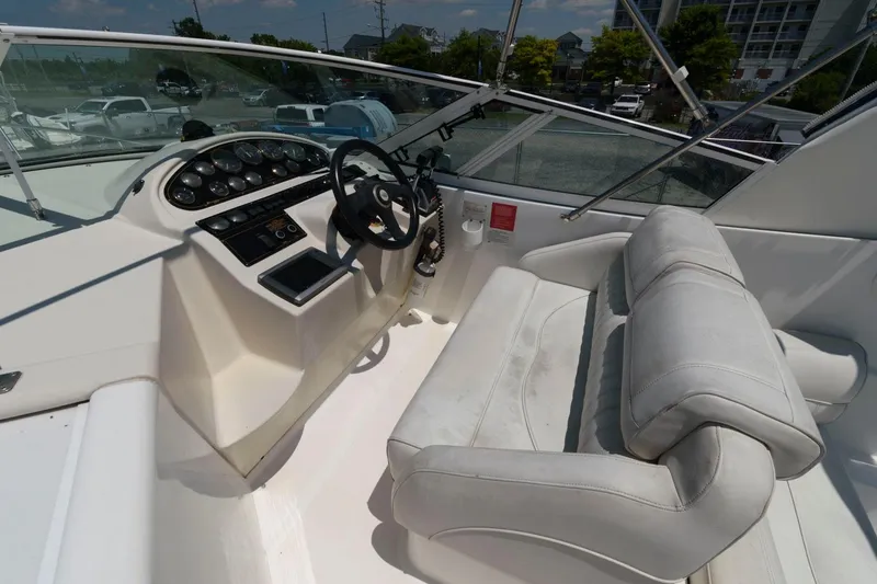 Slide: The Image of 2000 Cruisers Yachts 2870 Express helm station with steering wheel and control panel. - 3