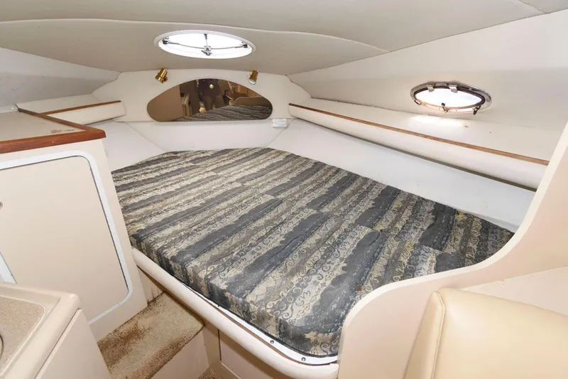 Slide: The Image of 2000 Cruisers Yachts 2870 Express cabin with bed and portholes. - 8