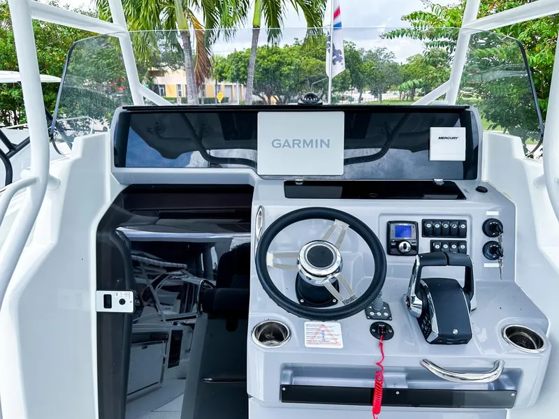 Slide: The Image of 2024 Jeanneau LEADER 9.0CC boat cockpit with Garmin navigation system and modern controls. - 11