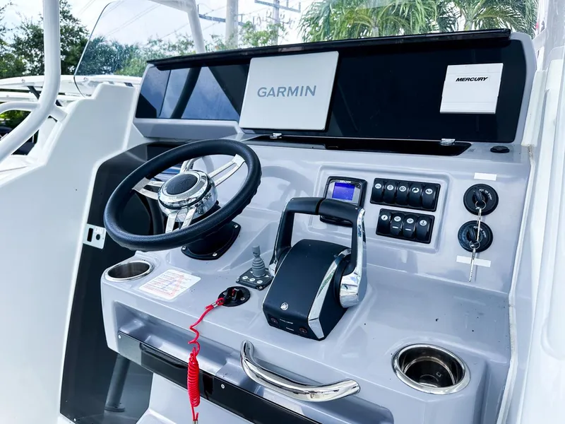 Slide: The Image of 2024 Jeanneau LEADER 9.0CC boat dashboard with Garmin navigation system and controls. - 12